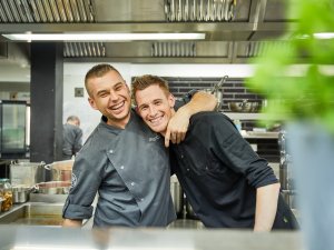 Zwei Mitarbeiter der Küche im Bergkristall haben Spaß bei der Arbeit.