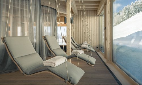 Ruheliegen mit Ausblick auf die verschneite Umgebung zeigen einen Einblick in den Wellnessbereich des Hotel Torghele's Wald & Fluh in Balderschwang
