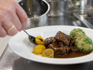 Eine Speise wird im Das Freiberg Romantik Hotel in Oberstdorf zubereitet