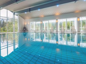Einblick in den großen Innenpool mit Fensterfront im Mondi Resort in Oberstaufen