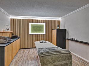 Raum für Massagen und SPA-Anwendungen im neuen Design mit Holzoptik.