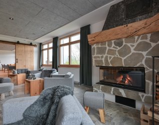 Einblick in die Lobby mit Kamin in Hartungs Hoteldorf in Hopfen am See.