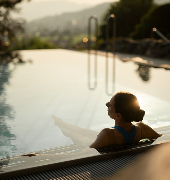 Ein Gast entspannt im Außenpool im Hotel Prinz-Luitpold-Bad in Bad Hindelang.