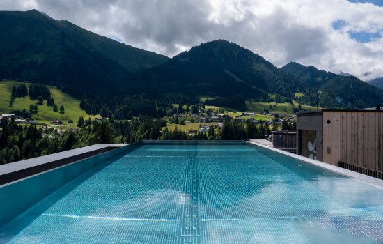 Außenpool mit Aussicht des Genuss & Aktivhotel Sonnenburg in Riezlern.