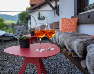 Zwei Aperol Gläser auf einem Balkon des DIANA Naturpark Hotel in Oberstaufen.