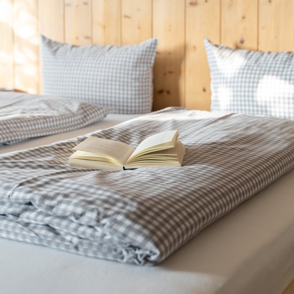 Alps Hostel Bett mit aufgeschlagenem Buch