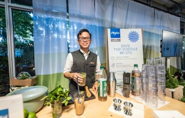 Ein Azubi der AzubiTopHotels beim Cocktail mixen bei einer Messe 2023.