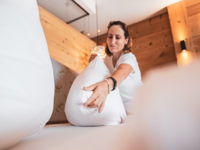 Eine Mitarbeiterin vom PANORAMA Allgäu-Spa-Resort in Rückholz beim Aufstellen eines Kissens