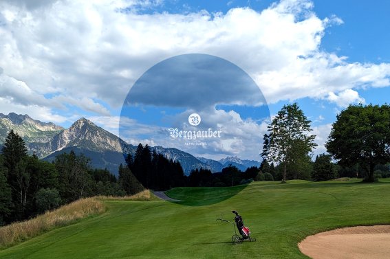 Spieler genießt den Golfplatz mit beeindruckender Alpenlandschaft unter blauem Himmel und vorbei ziehenden Wolken.