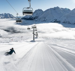 skier carving over a sea of clouds