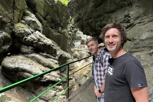 Johannes Zenglein und Industriekletterer Marc Segger stehen zwischen steilen Felswänden mitten in der Breitachklamm und blicken lächelnd in die Kamera.