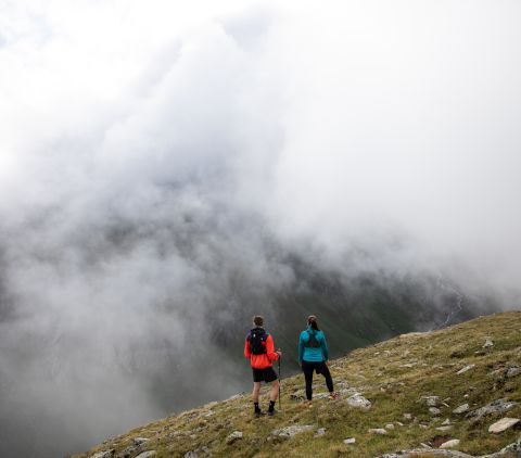 Fog on the mountain while trail running in the Alps Trail runners in the Ötztal Valley near the Explorer Hotel in Umhausen. Summer vacations in Tyrol for trail running, hiking, cycling, and all the other leisure activities an athlete's heart desires.