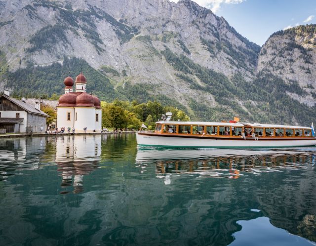 By boat across Lake Königssee near the Hotel Berchtesgaden Take a boat from Schönau across Lake Königssee and visit St. Bartholomä or start one of the countless hikes.