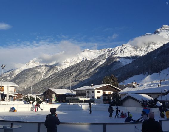 Eislaufen in Neustift mit Blick auf die Stubaier Berge.