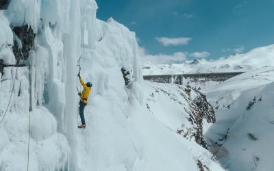 A man climbs upwards on the ice at the reservoir on the Bielerhöhe in Montafon.