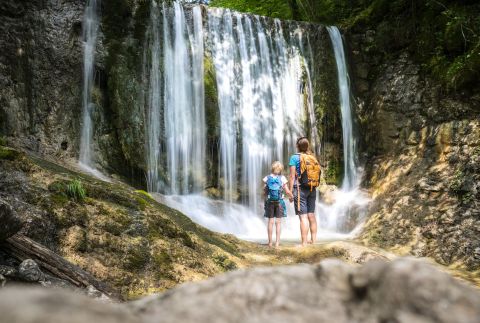A couple is looking at a waterfall.