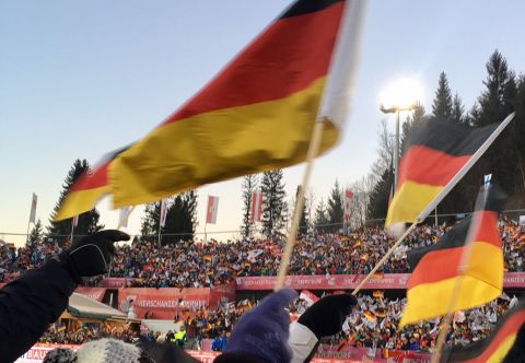At the opening competition of the Four Hills Tournament in Oberstdorf, the jumpers are cheered on by a large crowd.