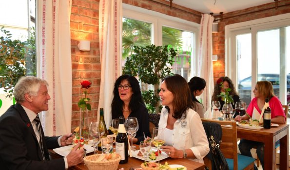 Gesellige Dinner-Atmosphäre im Restaurant Gäste genießen ein köstliches Essen und tolle Gespräche in einem einladenden Restaurant an einem Abend.