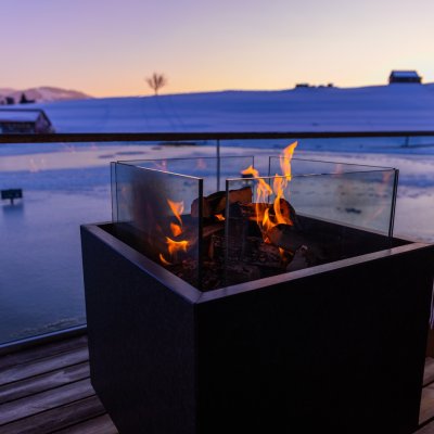 Ein kleines Feuer am Haubers Natursee zur Winterzeit. Ein kleines wärmendes Feuer am Haubers Natursee abends im Winter.