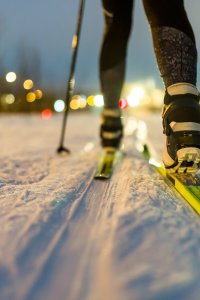 Image-from-back-skier-with-sticks-background-burning-lights