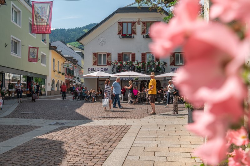Sommerliche Innenstadt von Lienz in Osttirol mit historischem Stadtbild und gemütlicher Atmosphäre. Lienz ist ein beliebtes Ausflugsziel für Gäste im Nationalpark Hohe Tauern und von Prägraten am Großvenediger aus gut erreichbar. Ideal für einen Stadtbummel, Shopping, Cafés und Kultur.