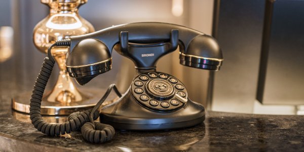 Stilvolle Grandhotel-Details im Hotel Mohren Oberstdorf: Das elegante Retro-Telefon an der Rezeption erinnert an die Tradition und Geschichte des Hauses. Hier verbindet sich klassisches Ambiente mit moderner Gastfreundschaft – für einen Urlaub im Allgäu mit besonderem Flair.
