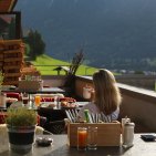 Ontbijt met uitzicht op de bergen in Hotel Oberstdorf in de Allgäu. Gasten genieten van een heerlijk ontbijt op het terras van Hotel Oberstdorf met uitzicht op het Allgäugebergte – een perfecte start van de vakantiedag.