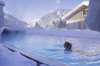 Außen-Sole-Pool im Winter im Hotel Oberstdorf Gegensätze ziehen sich an. Besonders faszinierend ist das bei einem entspannenden Bad im Hotel Oberstdorf Pool zu spüren, um einen herum dicker, weißer Schnee glitzert.