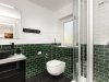 Moderne Badezimmergestaltung mit Dusche und Toilette Das Badezimmer zeigt eine Dusche, eine Toilette und eine Waschbeckenfläche. Die Wände sind teilweise grün gefliest.