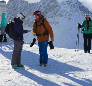 skilehrer beim ueberpruefen des verschuettetensuchgeraets