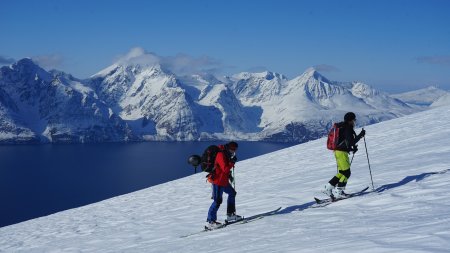 2 tourengeher im aufstieg, wasser und berge