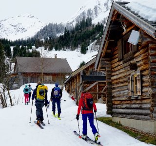 skitourengruppe, blockhaus, almdorf, grauer himmel