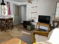 Wohnzimmer mit Fernseher und Kaminofen