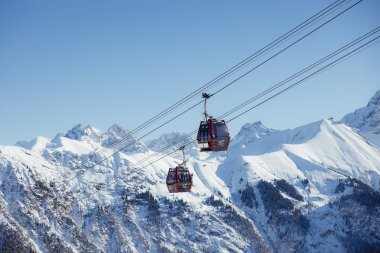 Seilbahnen fahren durch die hochgelegenen Alpen im winterlichen Schnee und bieten einen atemberaubenden Blick auf die Berge.