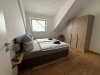 Schlafzimmer mit Bett und Schrank im Dachgeschoss