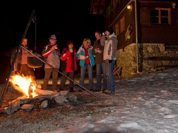 Zur Begrüßung unserer Gäste gibt es im Winter am knisternden Lagerfeuer vor der Wannenkopfhütte einen Glühwein-Empfang.